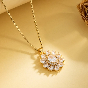 Elegant gold sunflower necklace with oval zircon pendant on a textured beige background
