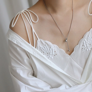 Silver bead snake chain necklace detail showing adjustable tassel drop on a model