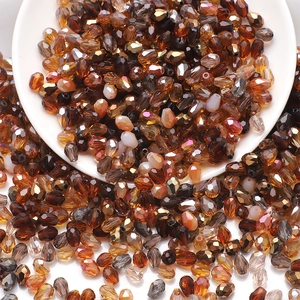 Macro shot of assorted faceted amber and champagne glass teardrop beads for DIY jewelry