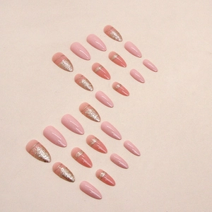 Glossy almond-shaped press-on nails with pink glitter gradient and gold striping