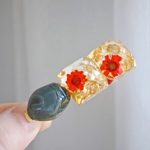 Resin hair clip with real red dried flowers, gold foil accents and dark green stone bead