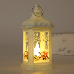 Detail of white Christmas LED lantern with Santa Claus patterns and glowing candle