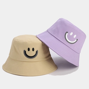 Cotton bucket hat set in khaki and purple featuring a minimalist smiling face design
