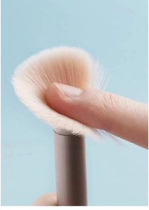 Close-up of soft synthetic bristles and macaron handle showing brush head elasticity