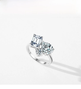 Macro detail of S925 silver ring featuring emerald-cut and pear-shaped cubic zirconia stones