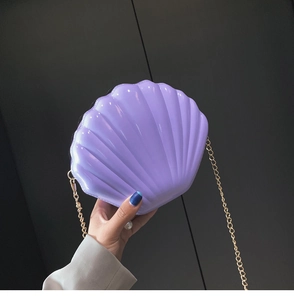 Detailed shot of lavender shell bag with pearl finish and gold chain strap