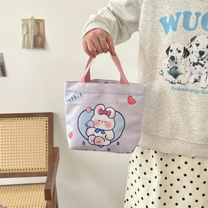 Close-up of cute cartoon rabbit print and strawberry pattern on lilac canvas tote bag