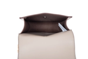 Detail view of the bag interior with snap button, brown lining, and inner compartment