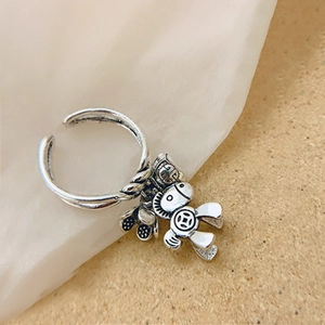 Silver open ring featuring a cute horse charm with an antique finish on soft fabric