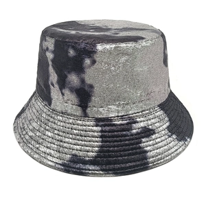 Detail of tie-dye bucket hat featuring metallic silver-grey fabric and stitched brim