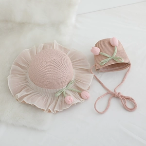 Close-up of pink straw hat with lace brim, tulip flowers and matching mini crossbody bag