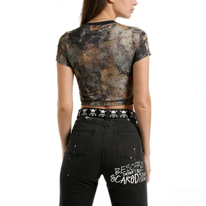 Gothic skull belt paired with black slim denim jeans and an abstract print crop top outfit