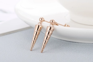 Macro shot of elegant rose gold conical spiral earrings with smooth metallic finish
