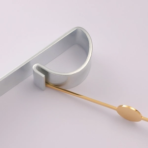 Close-up of polished stainless steel jewelry bending tool with gold and silver mirror finish