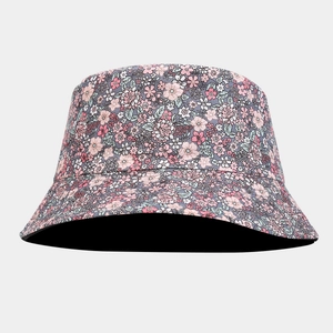 Detail of floral bucket hat with pink and white flowers on a navy blue background