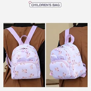 Cute lavender cartoon bear backpack for toddlers with 3D ears, shown in use on model