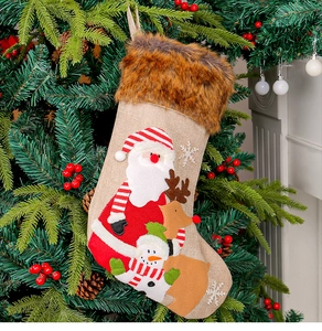 Close-up of plush Christmas stocking with Santa and snowman on a festive tree