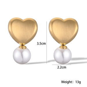Detailed view of heart-shaped gold studs with pearls and measurements 3.5cm x 2.2cm