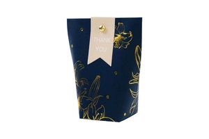 Detail of dark blue wedding favor box with gold floral patterns and Thank You tag