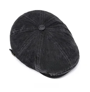Top view of a vintage washed black corduroy newsboy cap showing texture and button