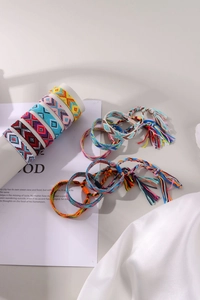 Detail of colorful hand-woven Bohemian friendship bracelets with geometric patterns and tassels