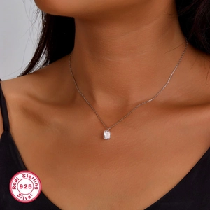 Detailed close-up of S925 sterling silver necklace featuring a square zircon pendant on a model