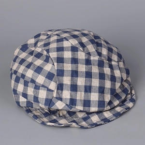 Detailed view of vintage cotton linen plaid beret fabric texture and blue check pattern