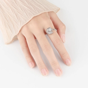 Rotating silver star and moon ring with clear crystals shown on a model's finger
