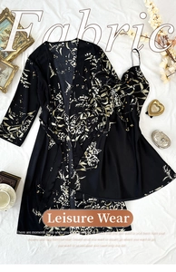 Flat lay of silk floral print pajamas set including robe and dress with retro props