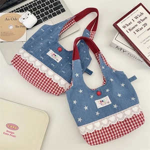 Close-up of contrast lace trim on denim and red plaid tote bags for women
