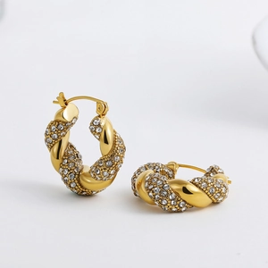 Detailed view of 18K gold plated twisted hoop earrings with sparkling pave diamond accents