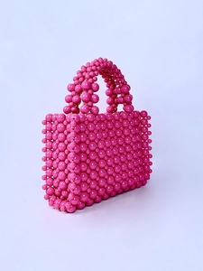 Pink pearl beaded handmade handbag with elegant French style on a white background