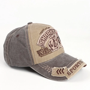 Detail of vintage washed canvas baseball cap with shark embroidery and distressed patchwork