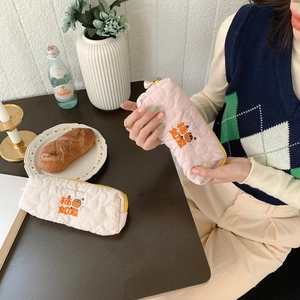 Detailed embroidery of orange persimmon on pink quilted cotton pencil case and makeup bag