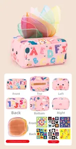 Detail view of pink baby tissue box toy with sensory scarves and educational patterns