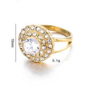Detail shot of a gold ring with circular clear gemstone cluster and split shank design