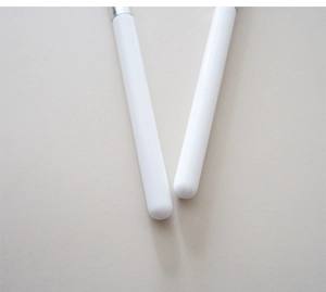 Detailed close-up of the sleek white handles and silver ferrule of makeup brushes