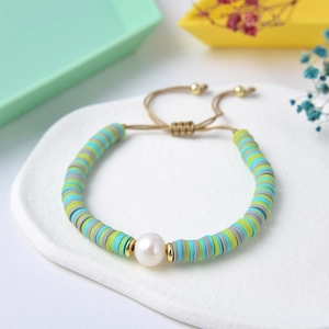 Colorful clay bead bracelet with pearl centerpiece and adjustable cord for layering