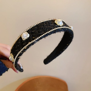 Detail of tweed headband with pearl and crystal flower embellishments in black and gold