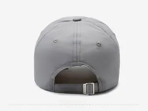 Close-up of adjustable silver metal buckle and breathable quick-dry fabric on grey baseball cap