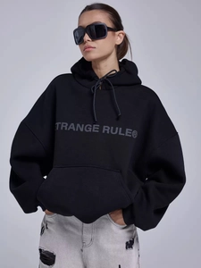 Detail of grey STRANGE RULE print on black oversized cotton blend hoodie