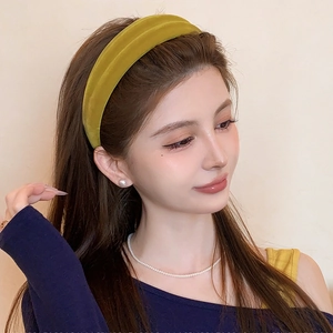Green flocked velvet headband worn by model showing vintage texture and high top volume