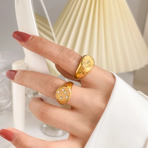 Detailed view of two gold rings featuring sparkling hexagram and star zircon inlays