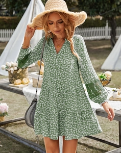 Detail of green floral mini dress with lace hollow-out sleeves and V-neckline