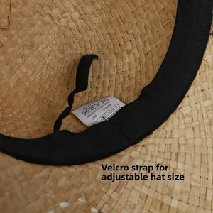 Detail view of natural raffia sun hat interior with adjustable black velcro strap