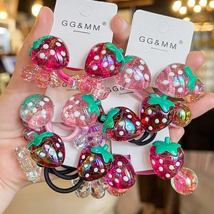 Detail of cute strawberry hair ties with white polka dots on elastic bands