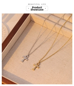 Detail of silver and gold Ankh cross necklaces with pavé zircon in a jewelry box