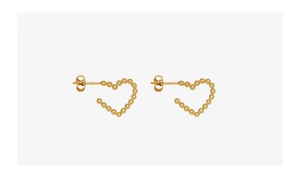 Detailed view of irregular heart earrings with golden beaded texture in titanium steel