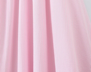 Detail shot of the pink and white vertical stripe seersucker fabric texture and drape