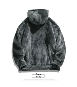 Close-up of thick plush fleece texture on dark grey oversized hooded sweatshirt